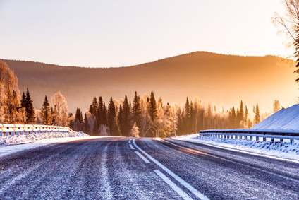 The road in the winter mountains in the background