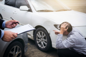 Traffic Accident and insurance concept, Insurance agent working on report form with car accident claim process