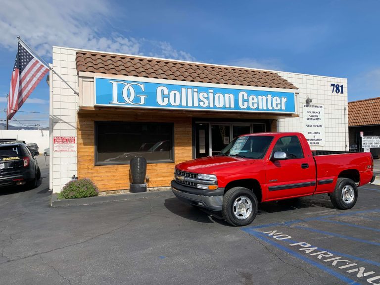 Red pickup truck after collision repair parked before DG Collision Center