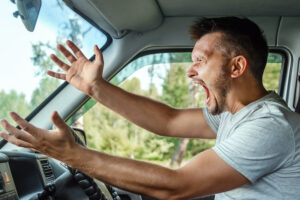 Aggressive Man, the driver of the car is outraged at the wheel during the trip. Emergency, accident, violation of rights, dispute, bad driver.