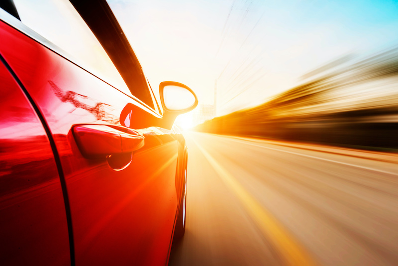 A car driving on a motorway at high speeds, overtaking other cars