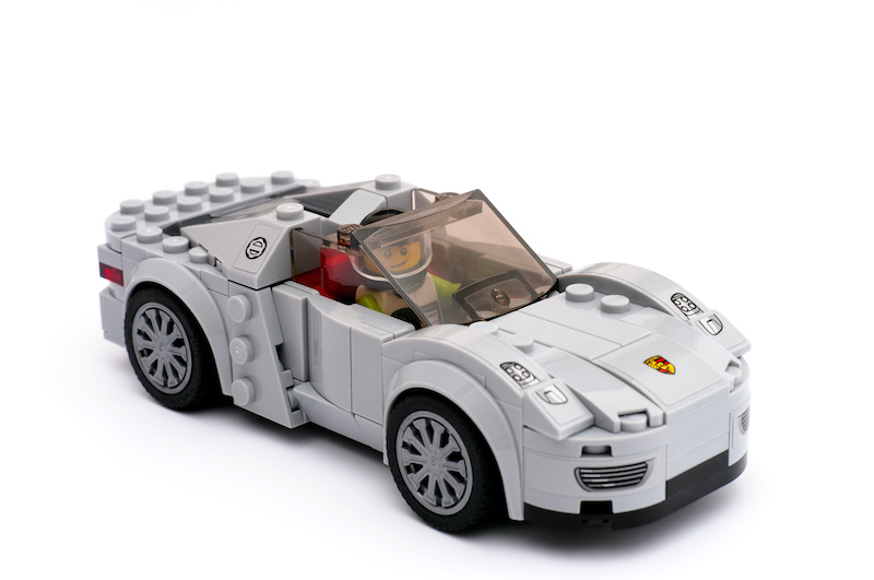 Tambov, Russian Federation - March 15, 2015 Lego Porsche 918 Spyder by Lego Speed Champions on white background with driver inside car. Studio shot.