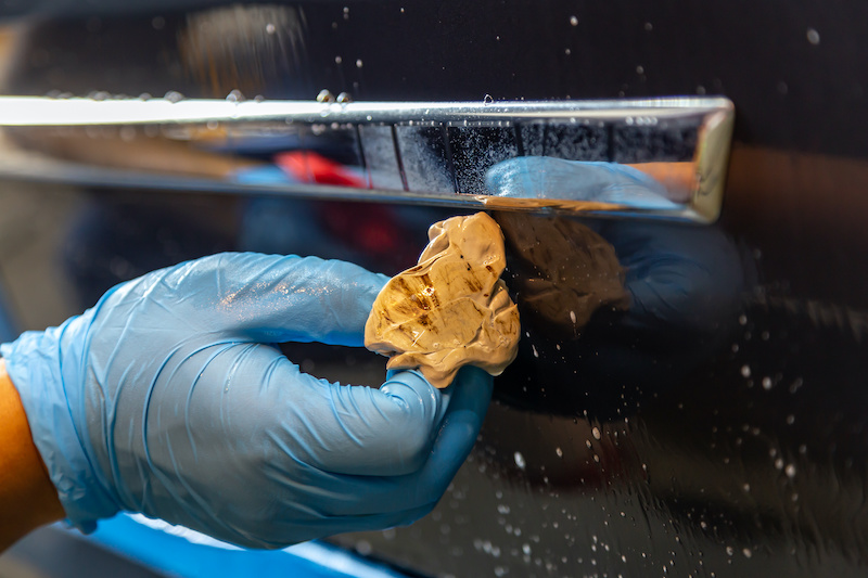 Clay bar full of debris and dust sfter car cleaning close up