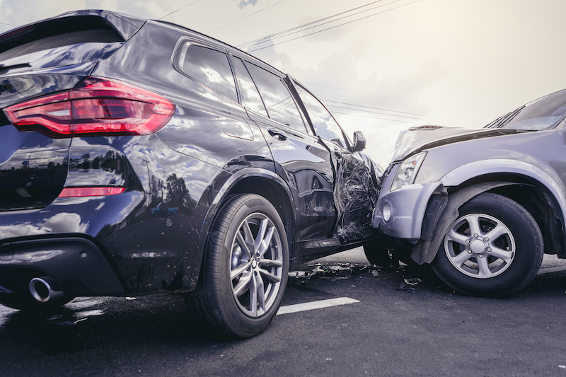 Car crash dangerous accident on the road. SUV car crashing beside another one on the road.