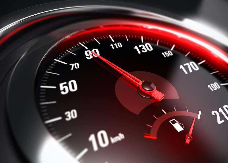 Close up of a car speedometer with the needle pointing 90 Km h, blur effect, conceptual image for safe driving concept