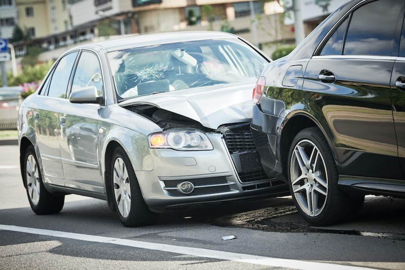 car crash accident. Car collision on city street. Two damaged automobiles