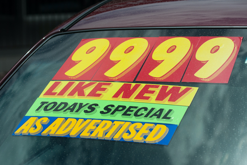 windshield sticker on a used car lot for sale