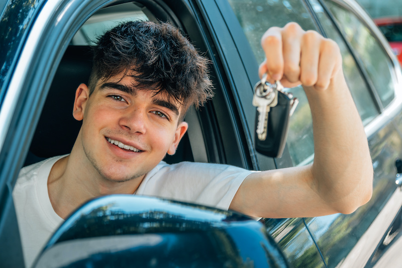 novice driver in the car smiling car care 