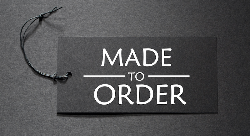 Made to Order text on a black tag on black paper background