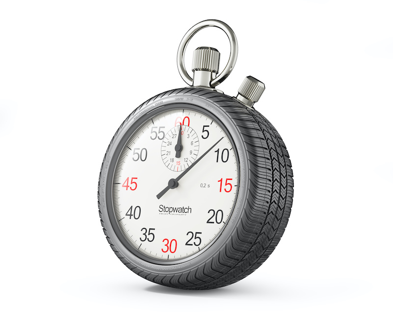 Stopwatch in form of car wheel on white background. Repair time after accident
