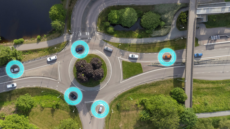 Intelligent transport system concept. Smart cars, vehicles with adaptive cruise control, artificial intelligence, sensors, advanced driver assistance system. Drone aerial view of cars in Sweden.
