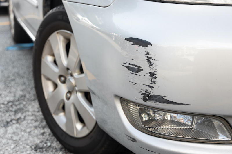 Scratch abrasion on car front bumper due to minor accident