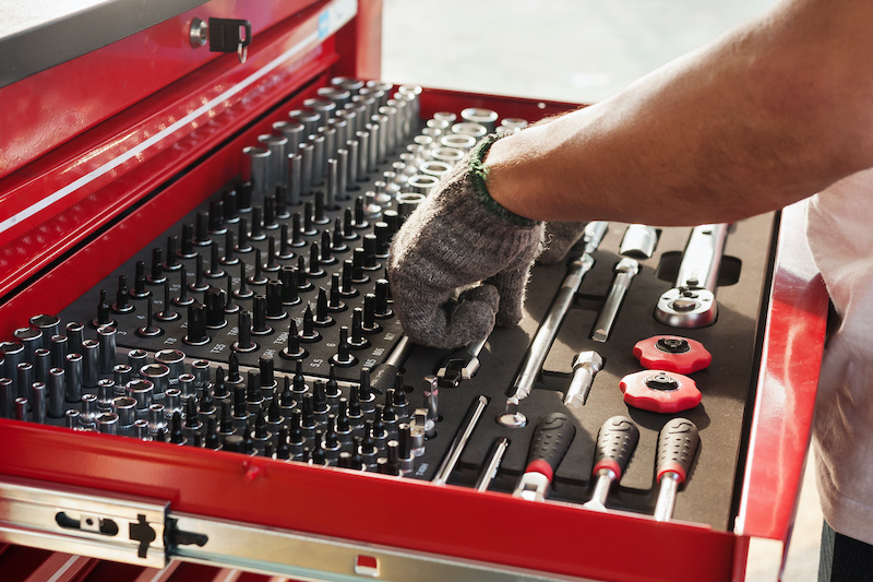 Hand picks a tool for car repair