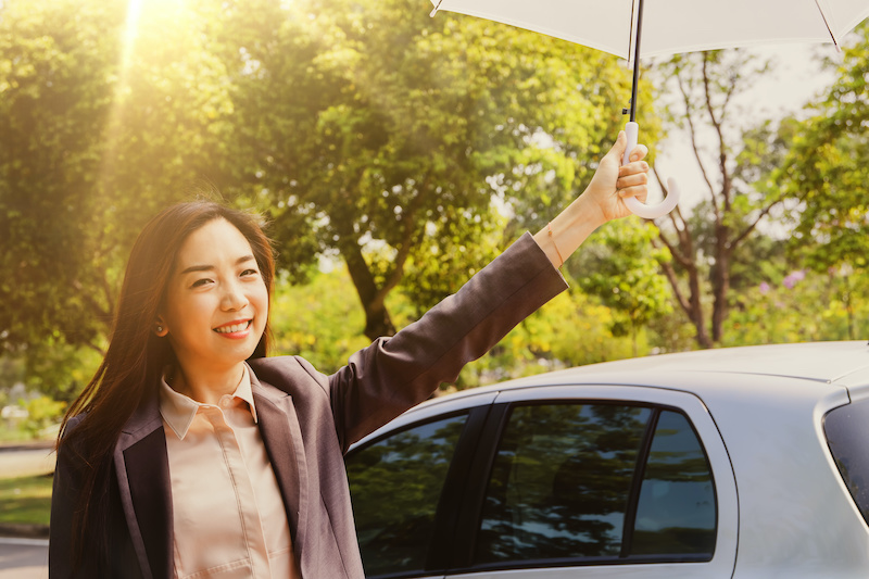 Portrait Asian business women use umbrellas to prevent ultraviolet (UVA) rays from the daylight in Southeast Asia, harmful to skin and to prevent skin cancer : Health care concept