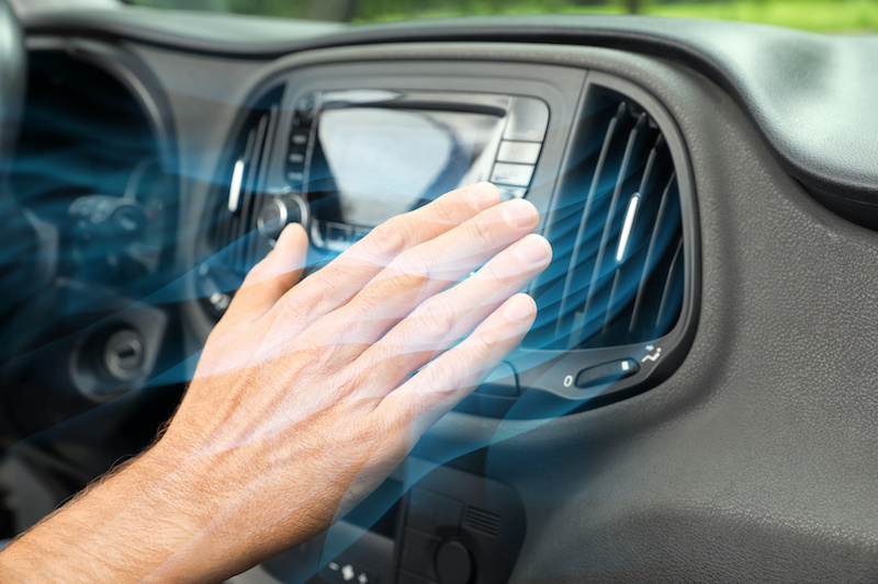 Man checking work of air conditioner in car, closeup