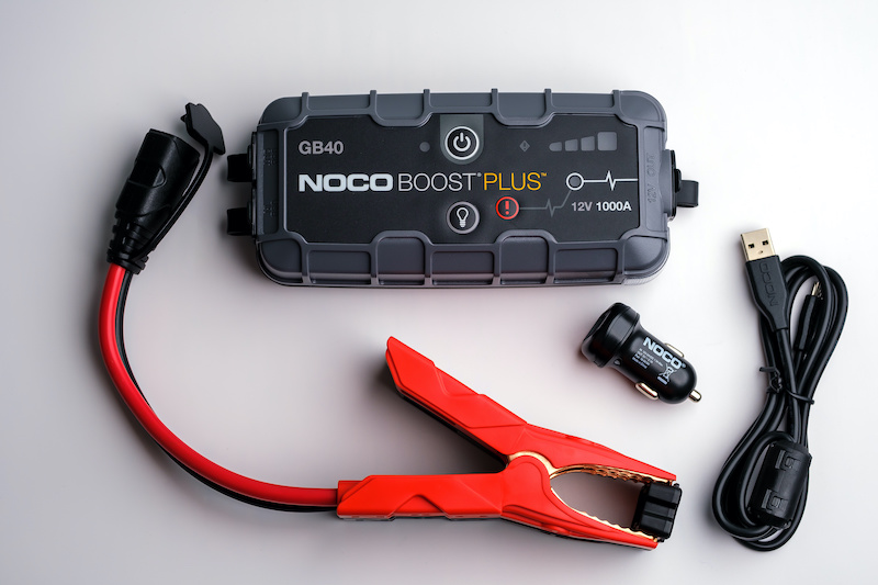 Car Jump Starter Noco Boost Plus GB40, and the content of the product box. Car battery starter kit. Stafford, United Kingdom, September 19, 2022.