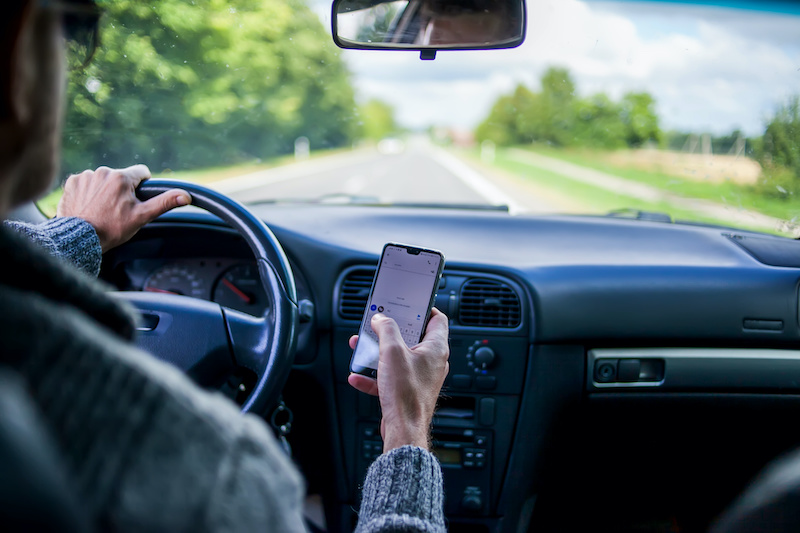 A man use sellphone while driving in the car. Road danger concept