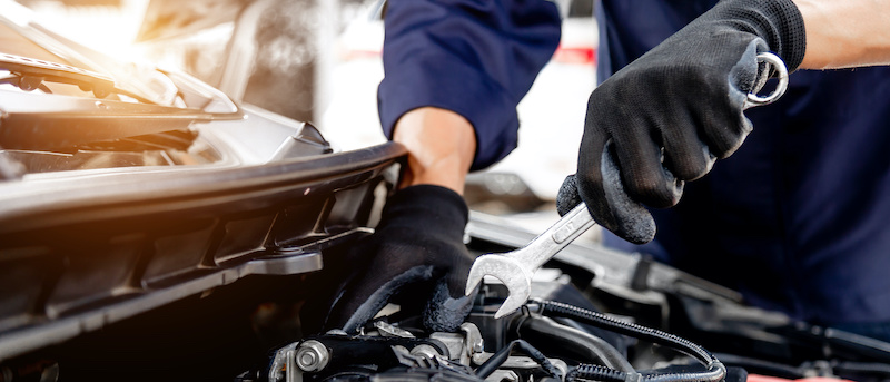 Car care maintenance and servicing, Close-up hand technician auto mechanic using the wrench to repairing change spare part car engine problem and insurance service support.