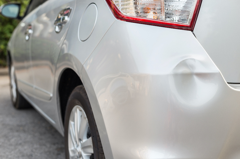 Backside of new silver car get damaged by accident