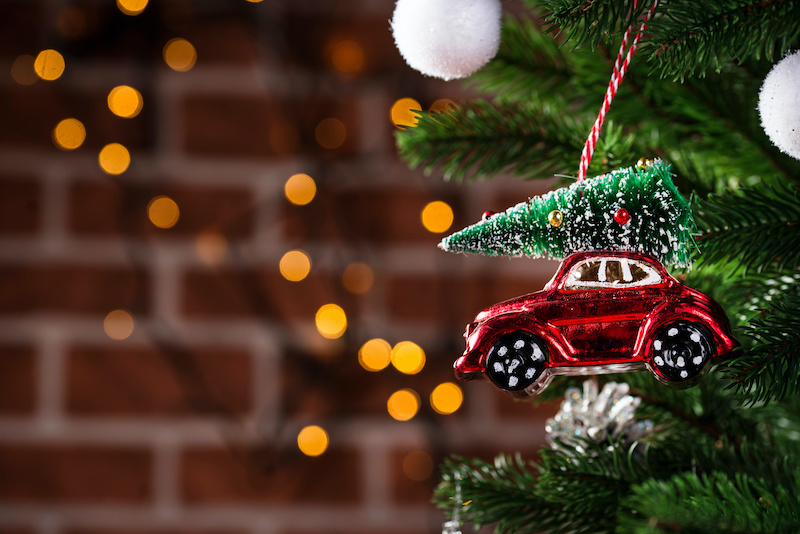 Christmas background with tree toy in shape of red car