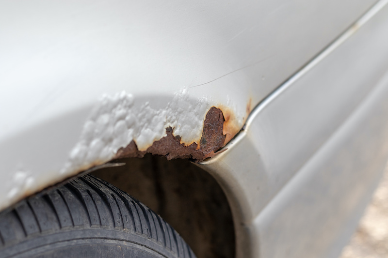 Rust on a silver car over the wheel