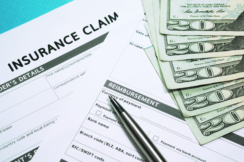 Insurance concept with insurance claim form and money