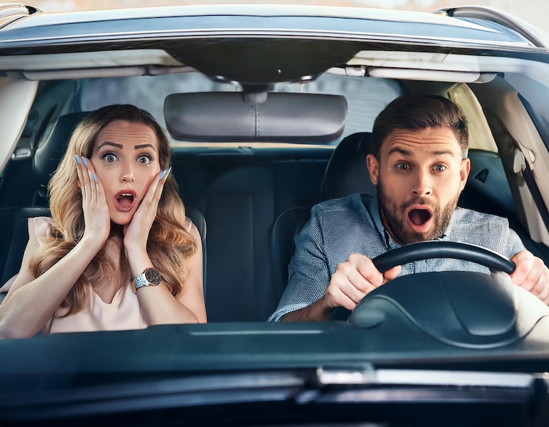 frightened passengers in the car during an road accident. Nervous lady and male driver with worried expression afraid to drive car by herself for first time or having car accident on road.