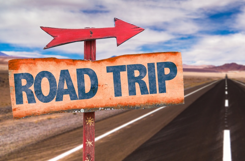 Road Trip sign with road background