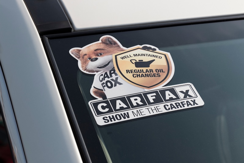 Cincinnati - Circa July 2021: Carfax sticker on a used pre-owned vehicle. Carfax provide vehicle reports for prospective buyers that may reveal problems.