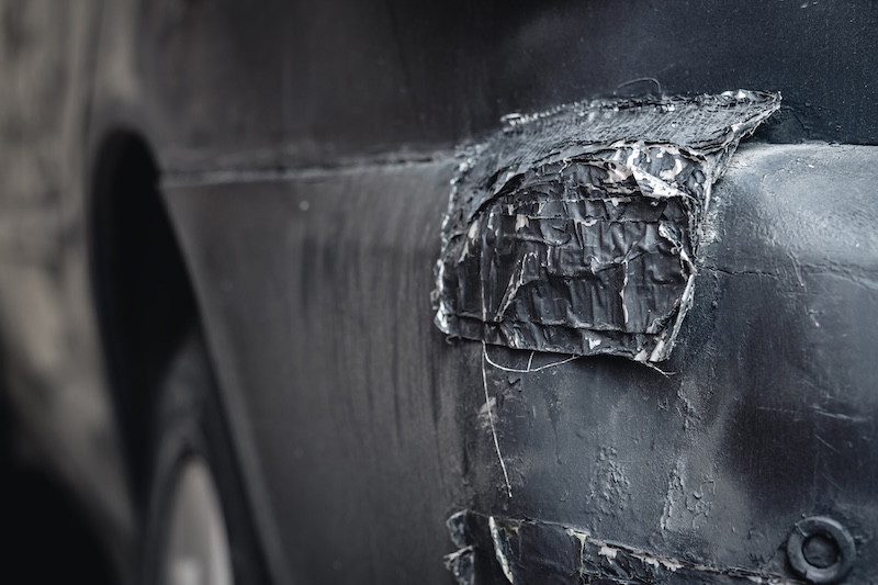 broken car bumper. old car, bad DIY repair.