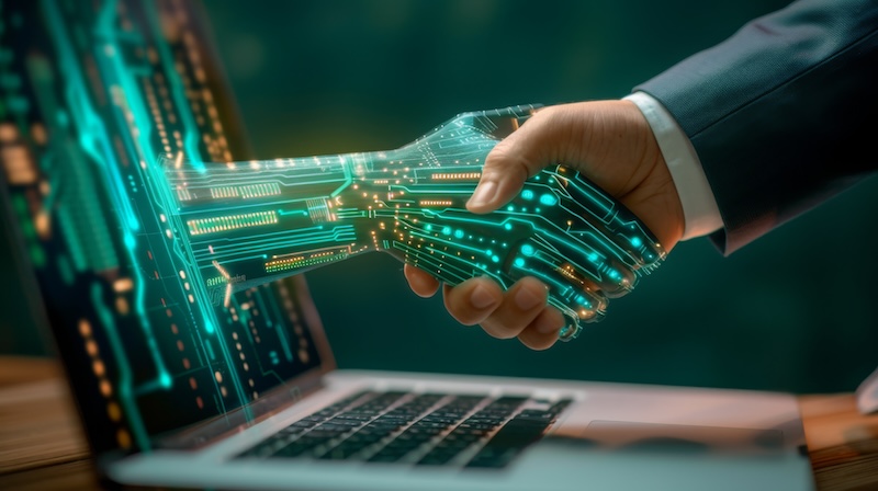 a human businessman shaking hands with a digital AI hand coming out from a laptop screen, symbolizing AI collaboration, vibrant Blue background, cybernetic circuits and technology glowing on AI hand --chaos 10 --ar 91:51 --v 6 Job ID: 1dc4e024-bb5d-4c1d-b30d-bcd041cbb87c