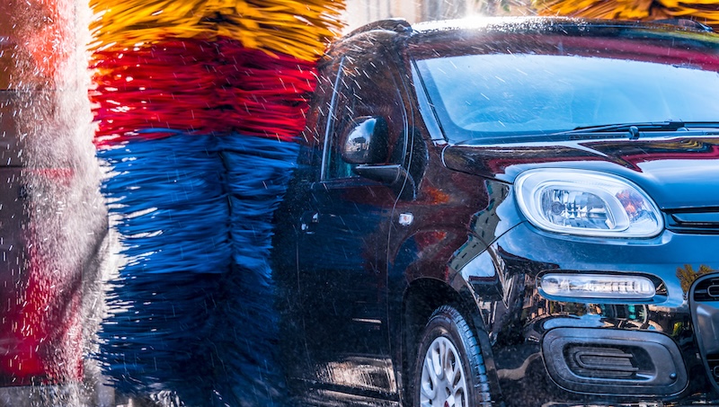 Car going through an automated car wash machine.