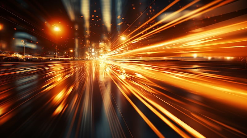 golden beams of light from headlights in blurry zoom traffic in the night city, traffic speed abstract background nightlife