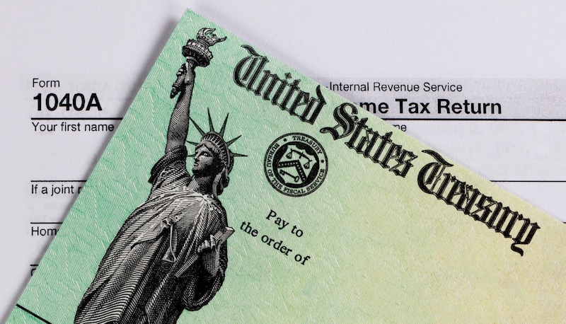 IRS refund check and tax form in close up view