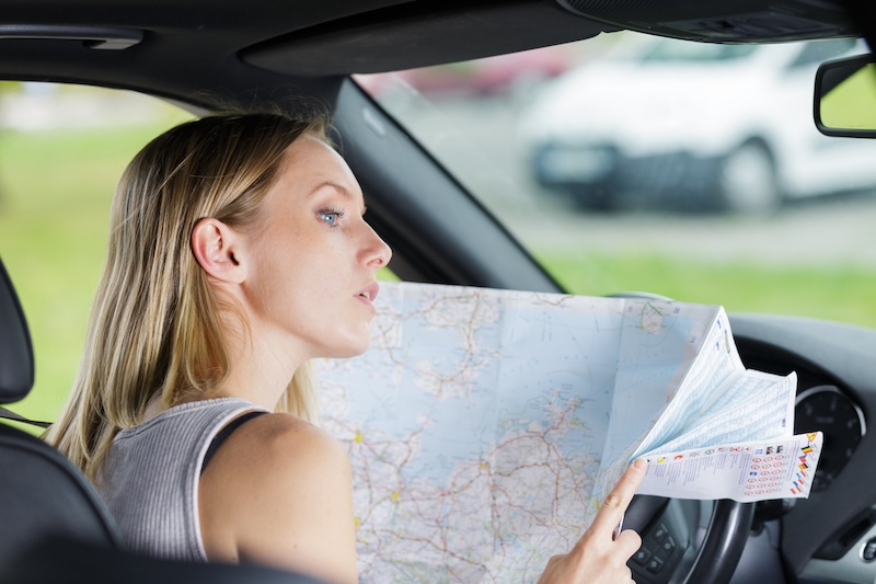 female driver inspecting the site located on the map