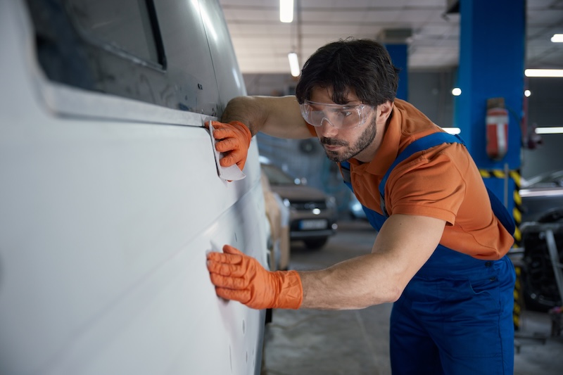 A mechanic is fitting and inspecting a car panel in a busy shop, wearing safety gear for protection. Man wearing work clothes is focused on his work SSUCv3H4sIAAAAAAAACoRUy47cIBC8R8o/jHxeFGNsg/cDcouSe5RDA+0dNNhYGG+yWs2/B79mcDTR3tzVdFXTVPv986fTKZMwGpU9n97nKMbG2mkMHoJxfYTzpw332Gv0KfLqWZ2nAJg0Qm2C8wZsCkoI6txDhxHsJ2tn+LokszFAmEYck15U7MR1bRiqCLKdQznrJi/dnxQczi44PfV4AF2v51KayCgI+BL7OgjtQ/i5xqc9sepBiKnsB/jL+OX7FLRzPntKDoyTnA98M6NCa6FHN43Znl9l/8eJbrD4iOwrdMbOTd541o9ft2G/YK/e7neYS89TCOjjzNQlvUxM0fxGtDPMHNpJfHy8qupHFdojdGMwywMeKqIV0ms0x5BS/rABC93bP0yslaqUbU6Y5AUpgbdENKomyAqqJUeO7ZGbqboWAiRpuVKkVLFU1DWShtKYwSKPZHfx9eOaOMKjRViNt/WRUdGibFlOCglIyjyviKBSEl5UFFCWJUOxUK53yS6/49y7xVEbKUzauMRhr06BnQ+wRBnMAB4OdYM3yvQvCeLCedm721K4qQ9+nlq2jyGzzg0go5OeT22UwR0/wzjG43rH0z1YdivR6V1YZrCxZjouyhxSVua1aFgjyiIvBWfb9LeFPZvIs7SzNzgN1oFGffDmYZUprymvqoqWdyvcdpXXRRQqqnJ7qf0ucTE6E/39ES+njeB33vRvMXNT0RSsSnSTH8eiTRt+0z78nuKaGJ2+lZlbySrMS2yEjH7TDSmbmhEQRUVymTNgDWtp3UavXP8CAAD//wMA6naj8W8FAAA=