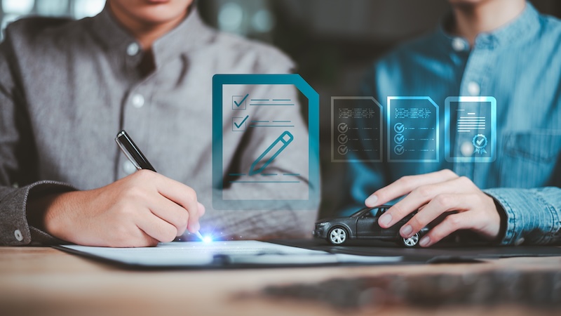 Insurance agent reviewing car insurance documents and digital policy approval with client, supporting automotive coverage, financial protection, contract verification, and claim service.