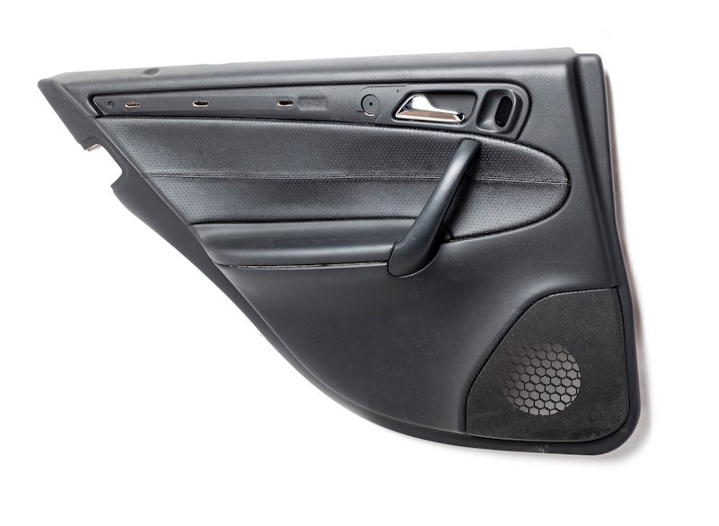 Car door trim with black leather upholstery on a white isolated background for repair and replacement in a car service. Spare parts catalog.
