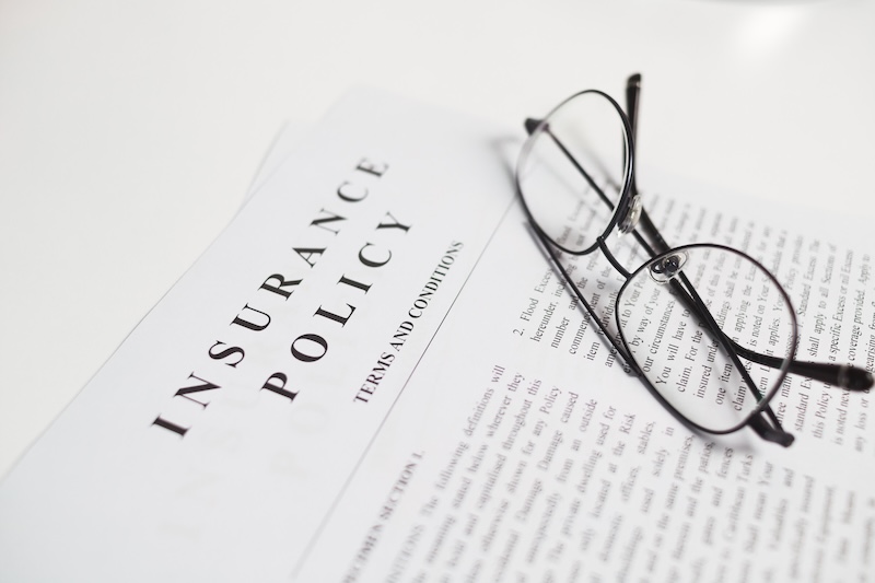 Insurance agent reviewing car insurance documents and digital policy approval with client, supporting automotive coverage, financial protection, contract verification, and claim service.