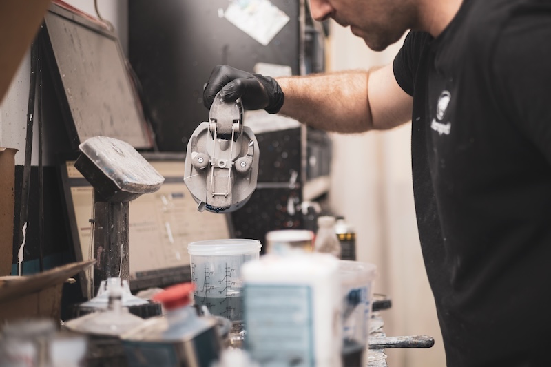 a mechanic mixing paint in an auto body shop.Repair and restore vehicles.