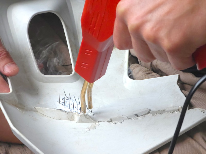 Man repairing plastic bumper with hot stapler tool. Automotive technician fixing crack on car body part. Professional vehicle bodywork and restoration service, maintenance concept. SSUCv3H4sIAAAAAAAACpySz26DMAzG75P2DijnIhGglO5Vqh1M4hZraVIlodNU9d2XP1Bl193wz/ZnfzGP97eqYhM4EuyjesQoxKTU4rwFT0YH3OxWblFLtCW5225oSgBURijJG0ugSjiBF7OGKwaoF6UifqYkcx784tDFXVYkwOMlaGT4ksgLn3JcbYmUDB0hxdiuYG6ZEttQFv9XZ/74fBm+oBY/aeHCiEWFkI2ccin7+vZor6U1WCSZwtXdCFCxoCuUgG5g4U/fzZIgfSmI8XO6y6YkzKK9jVu9zDBlzA0mFV/9HMbgxmdwLpTLjRezRfgLzLWYo41PnlZVJsNxYsi7vh0a3re8P/DDOI7tWpAPOlPQSetsQiEWXyRLVxQ3YIM4IxfTvkbeDHW/F8d6bDusm54fjxwPzYAy3OL5CwAA//8DAEBQJXW5AgAA