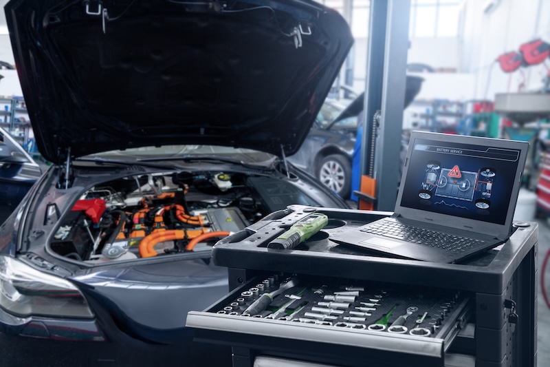 Car service workshop with cars on a column lifts.