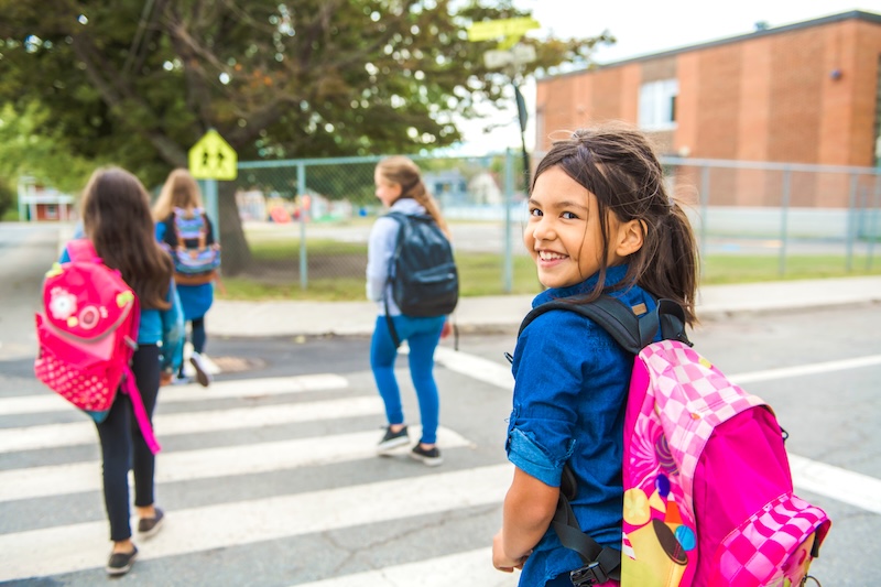 The kids on the school background on day time school zone safety