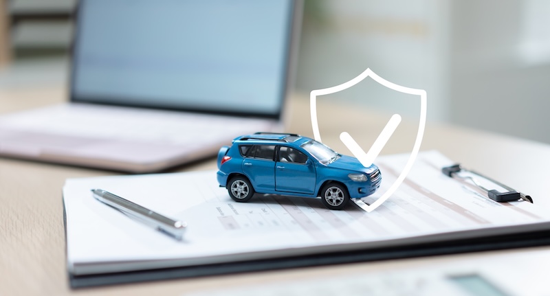 Car on insurance documents with a protection shield icon, representing auto insurance, vehicle coverage, risk management, policy protection, claims processing, and financial security.