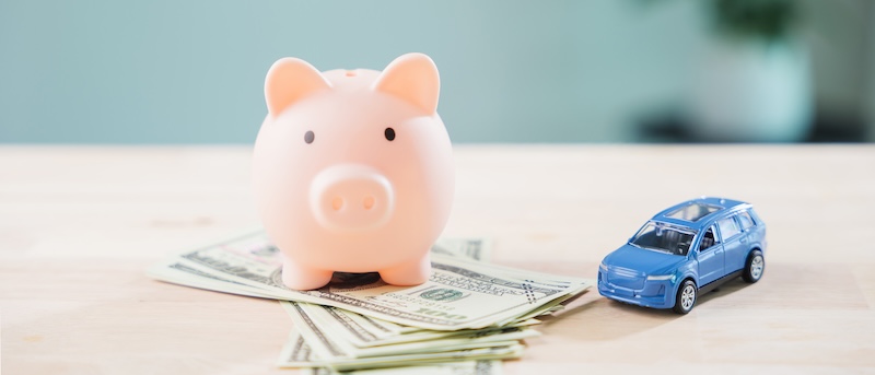 Pink piggy bank to save money for auto car fuel and refinance loan, finance gas transportation cost while managing personal budget for monthly vehicle insurance and drive cost. OriginalFilename: 25680901-_AAF9203.JPG