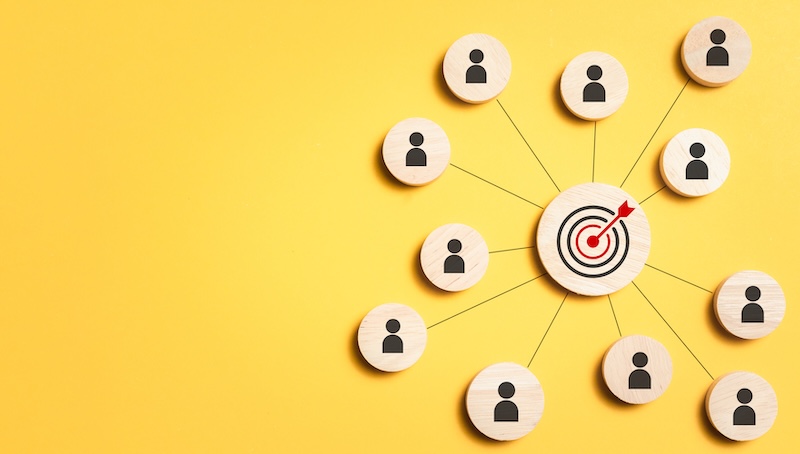 Customer relationship management concept. wooden block with target icon linked with human icons for customer focus group. Data exchanges development and customer service.