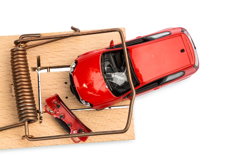 a model car in a mousetrap, symbolic photo for car expenses and liabilities hidden collision repair damage
